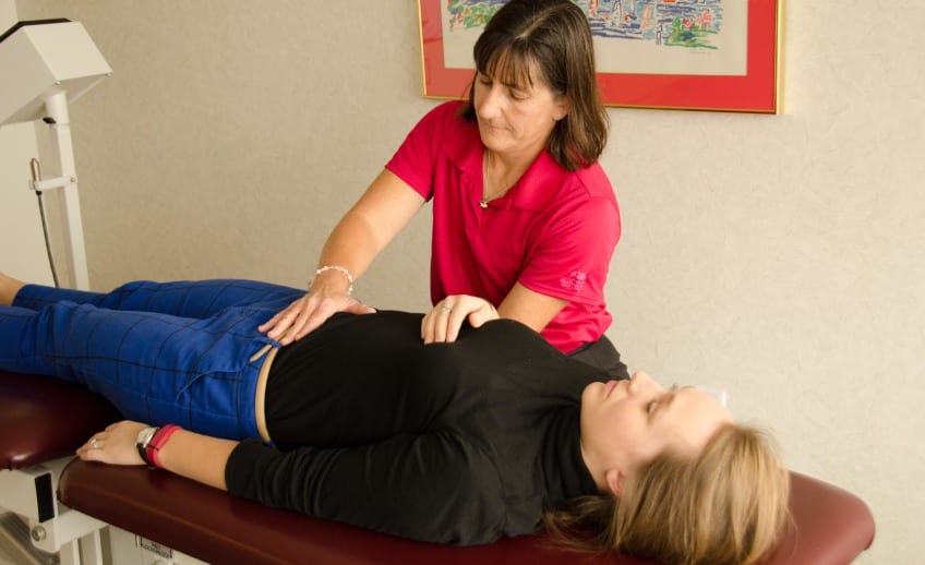 physical therapist performs visceral manipulation technique